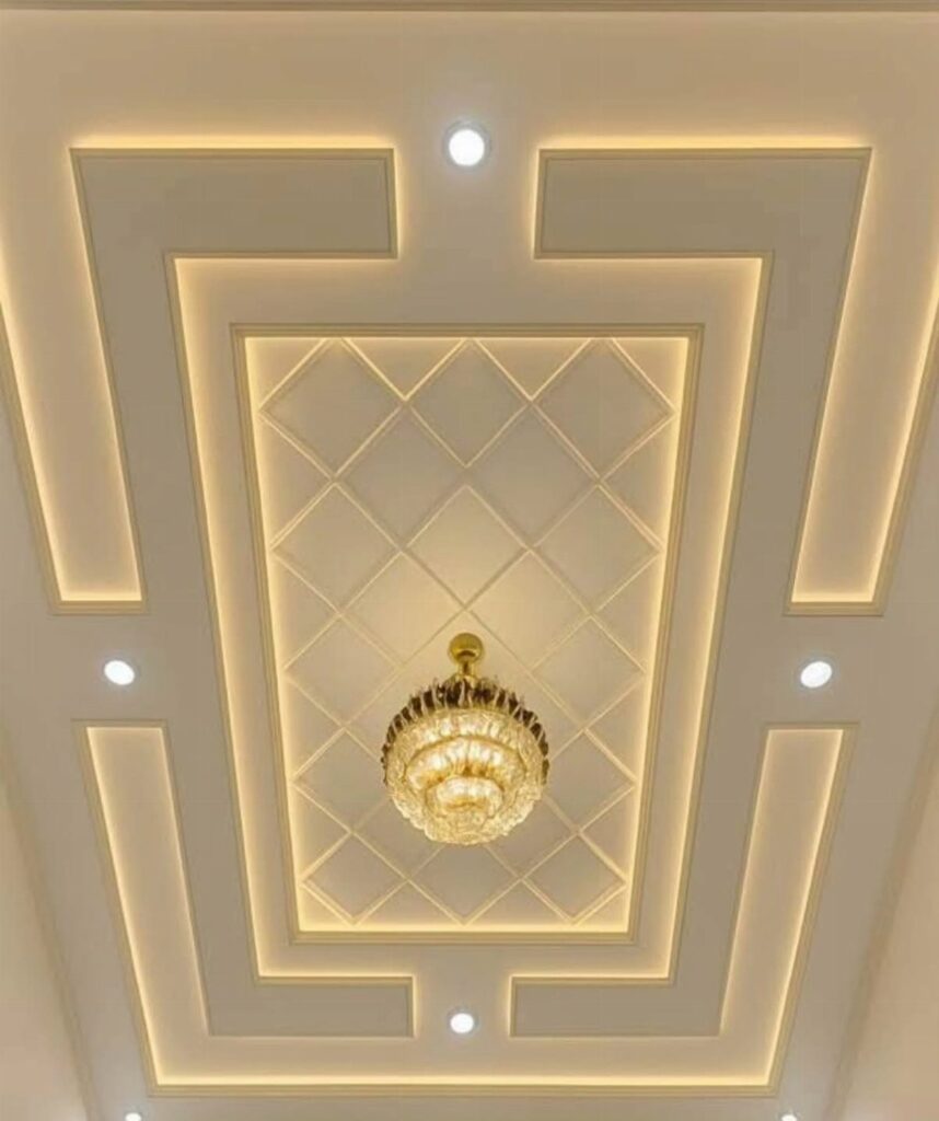 White tiered recessed ceiling with geometric LED lighting and a gold crystal chandelier.
