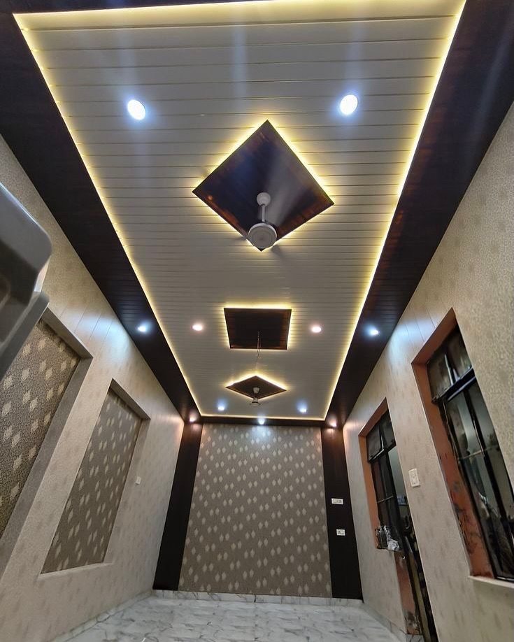 Modern PVC ceiling design with white panels, dark wood borders, and integrated LED lighting.