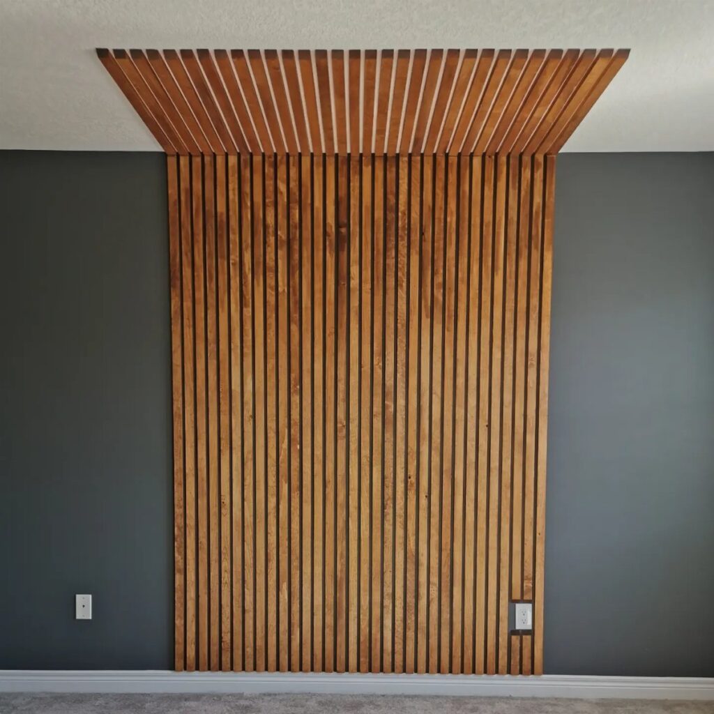 Vertical wooden slats mounted on a dark grey wall extending onto the ceiling.